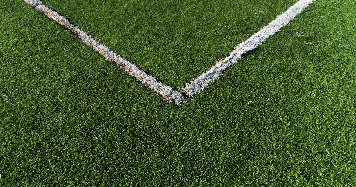 Close-up of a corner of synthetic turf with a white boundary line